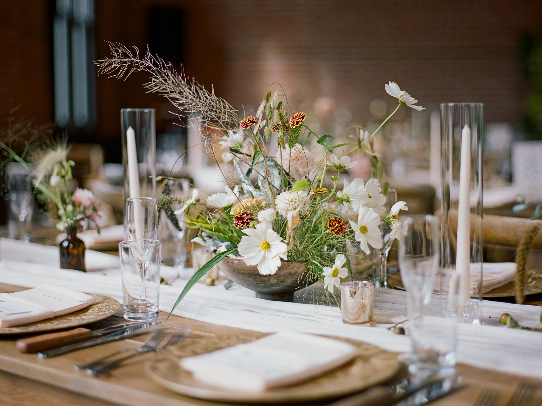 Seasonal centerpiece of cosmos, zinnias and grasses