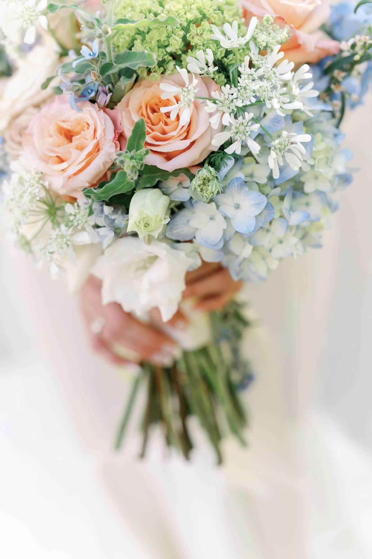 Bridal bouquet of peach roses and blue hydrangea